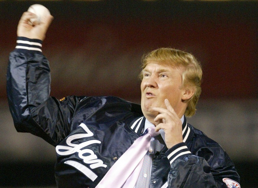 Businessman Donald Trump throws out the first pitch before the New York Yankees faced the Houston Astros, Friday, March 12, 2004, at Legends Field in Tampa, Fla. (AP Photo/Kathy Willens)