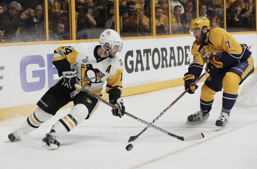 Nashville Predators defenseman Yannick Weber (7), of Switzerland, knocks the puck from Pittsburgh Penguins left wing Chris Kunitz (14) during the second period in Game 4 of the NHL hockey Stanley Cup  ...