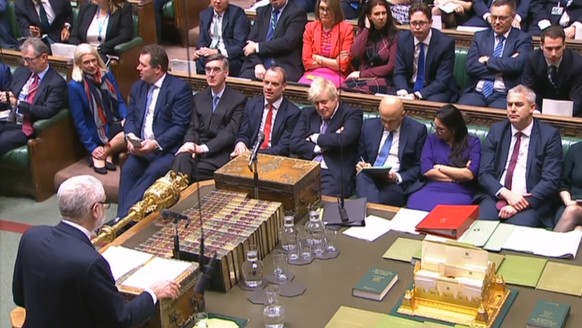 epa08083027 A grab from a handout video made available by the UK Parliamentary Recording Unit shows Labour party leader Jeremy Corbyn (bottom L) addressing MPs as British Prime Minister Boris Johnson  ...