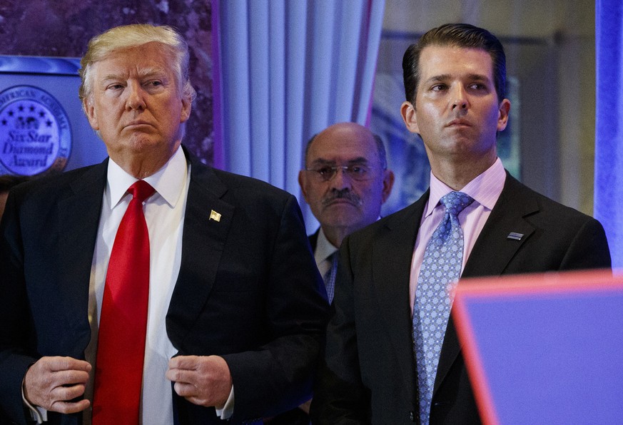 FILE - In this Jan. 11, 2017, shows President-elect Donald Trump, left, his chief financial officer Allen Weisselberg, center, and his son Donald Trump Jr., right, attend a news conference in the lobb ...