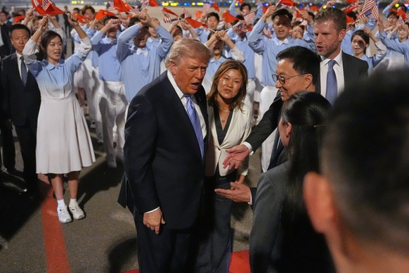 President Donald Trump is greeted during an arrival ceremony Wednesday, May 13, 2026, at Beijing Capital International Airport in Beijing, with Eric Trump, right. (AP Photo/Mark Schiefelbein)
Donald T ...