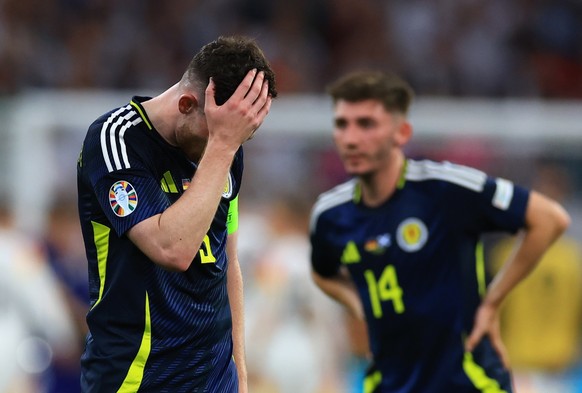 epa11411103 Andrew Robertson (L) of Scotland reacts after losing the UEFA EURO 2024 group A match between Germany and Scotland in Munich, Germany, 14 June 2024. EPA/MARTIN DIVISEK