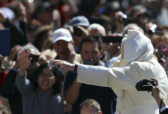 A gust of wind blows Pope Francis mantle as he arrives in St. Peter&#039;s Square for the weekly general audience, at the Vatican, Wednesday, May 14, 2014. (AP Photo/Gregorio Borgia)