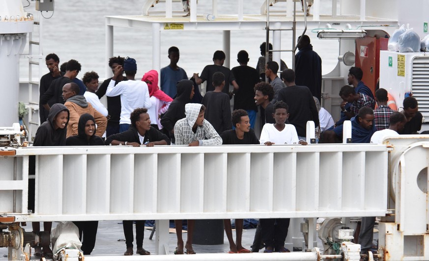 epa06961964 Migrants are seen onboard the Italian Coast Guard ship Diciotti moored in the port of Catania, southern Italy, 21 August 2018. The ship entered on 20 August in the port of Catania with the ...