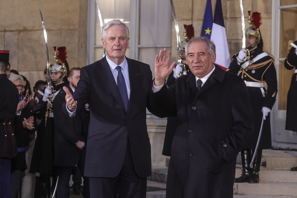 epa11775346 France&#039;s outgoing Prime Minister Michel Barnier (L) and France&#039;s newly appointed Prime Minister Francois Bayrou (R) wave during the handover ceremony at the Hotel Matignon in Par ...