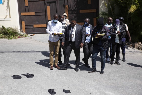 Security forces gather evidence around the perimeters of the residence of Haitian President Jovenel Moise, in Port-au-Prince, Haiti, Wednesday, July 7, 2021. Gunmen assassinated Moise and wounded his  ...