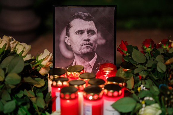 epa12370142 Candles stand in front of a photo of the deceased US political activist Charlie Kirk during a vigil in reaction to his assassination, in Berlin, Germany, 11 September 2025. Kirk was shot d ...