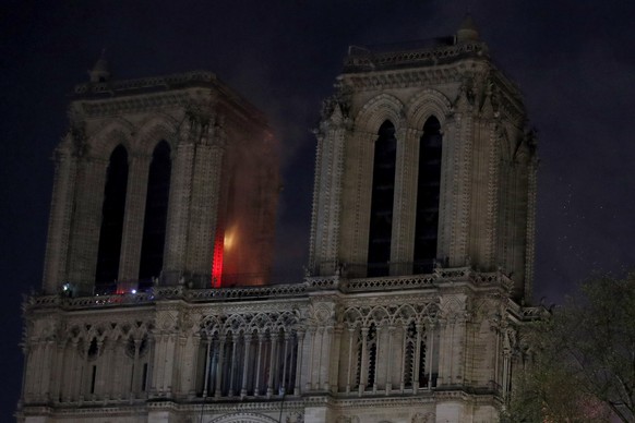 epa07508995 General view of the facade while flames are burning the roof of the Notre-Dame Cathedral in Paris, France, 15 April 2019. A fire started in the late afternoon in one of the most visited monuments of the French capital.  EPA/YOAN VALAT