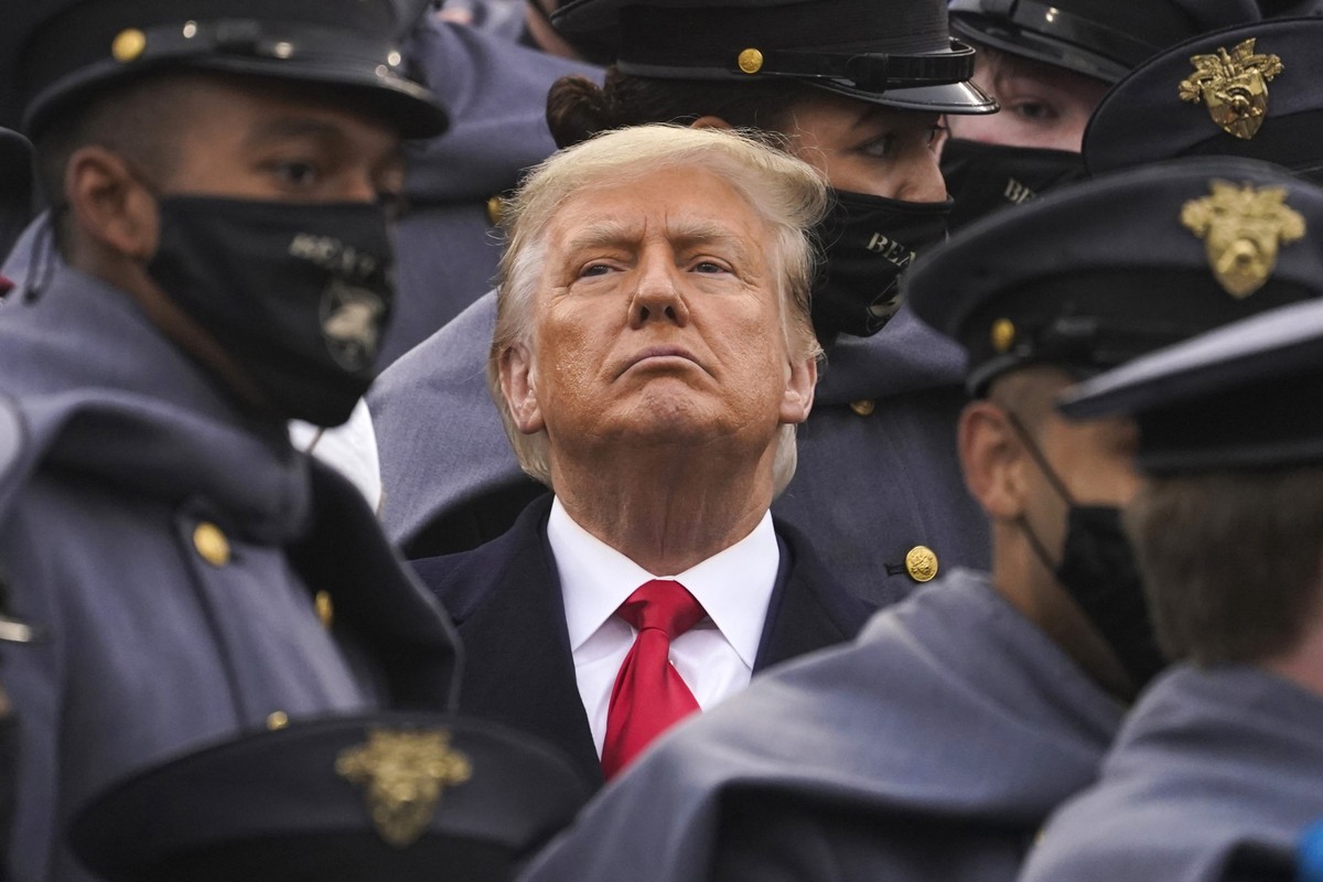 FILE - Surrounded by Army cadets, President Donald Trump watches the first half of the 121st Army-Navy Football Game, Dec. 12, 2020, in West Point, N.Y. When New York's Adult Survivors Act expire ...