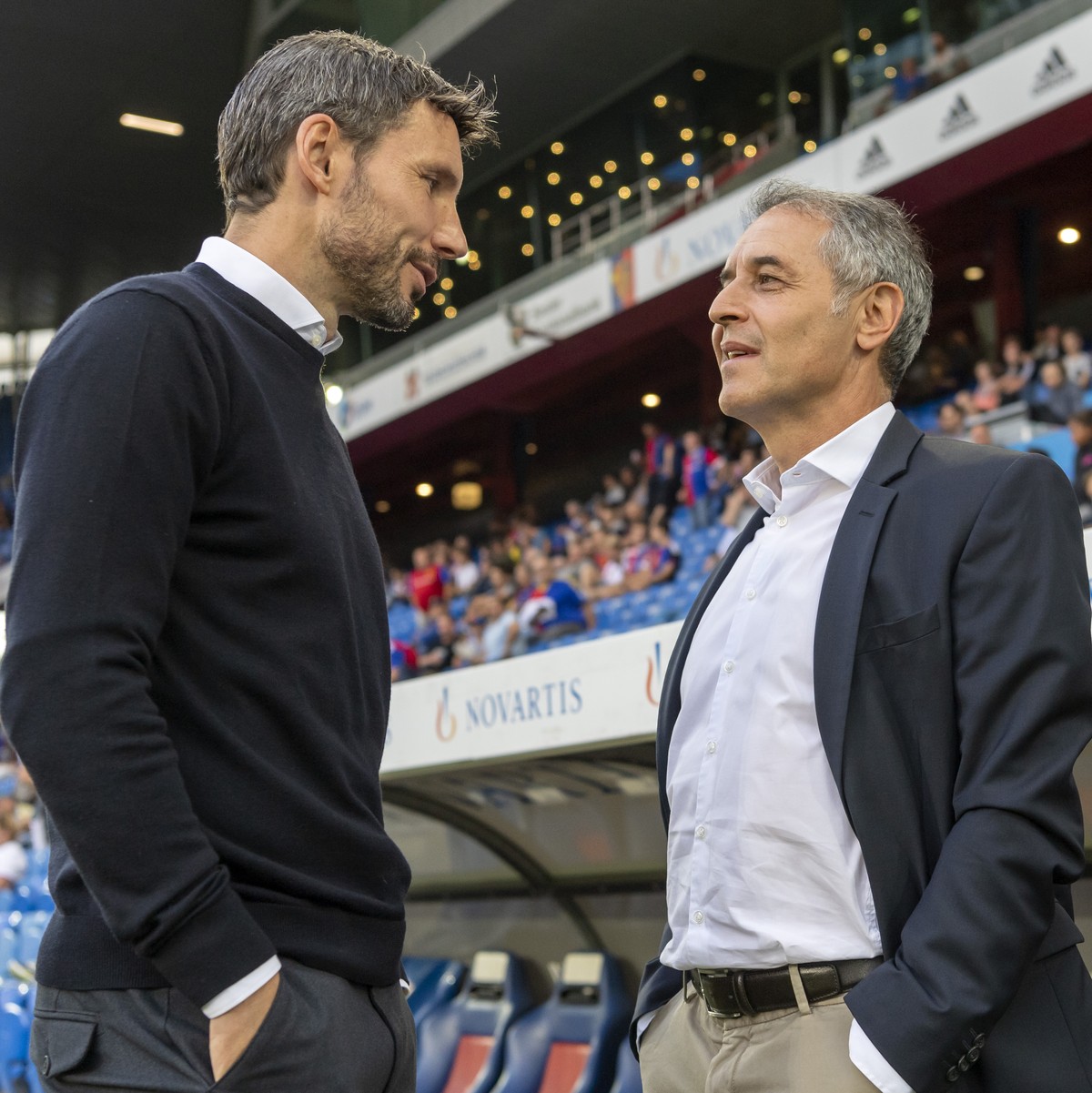 PSV's head coach Mark Van Bommel, left, and Basel's head coach Marcel Koller, right, prior to the UEFA Champions League second qualifying round second leg match between Switzerland's FC ...