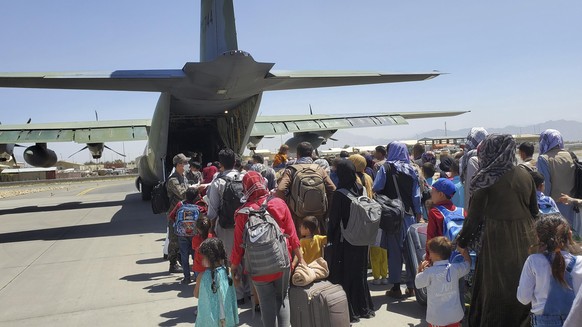 epa09429709 A handout photo made available by the Republic of Korea Air Force shows some 380 Afghans who have worked for South Koreans in their war-ravaged nation and their family members boarding a S ...