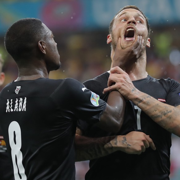 Austria&#039;s Marko Arnautovic, right, celebrates with Austria&#039;s David Alaba after scoring his side&#039;s third goal during the Euro 2020 soccer championship group C match between Austria and N ...