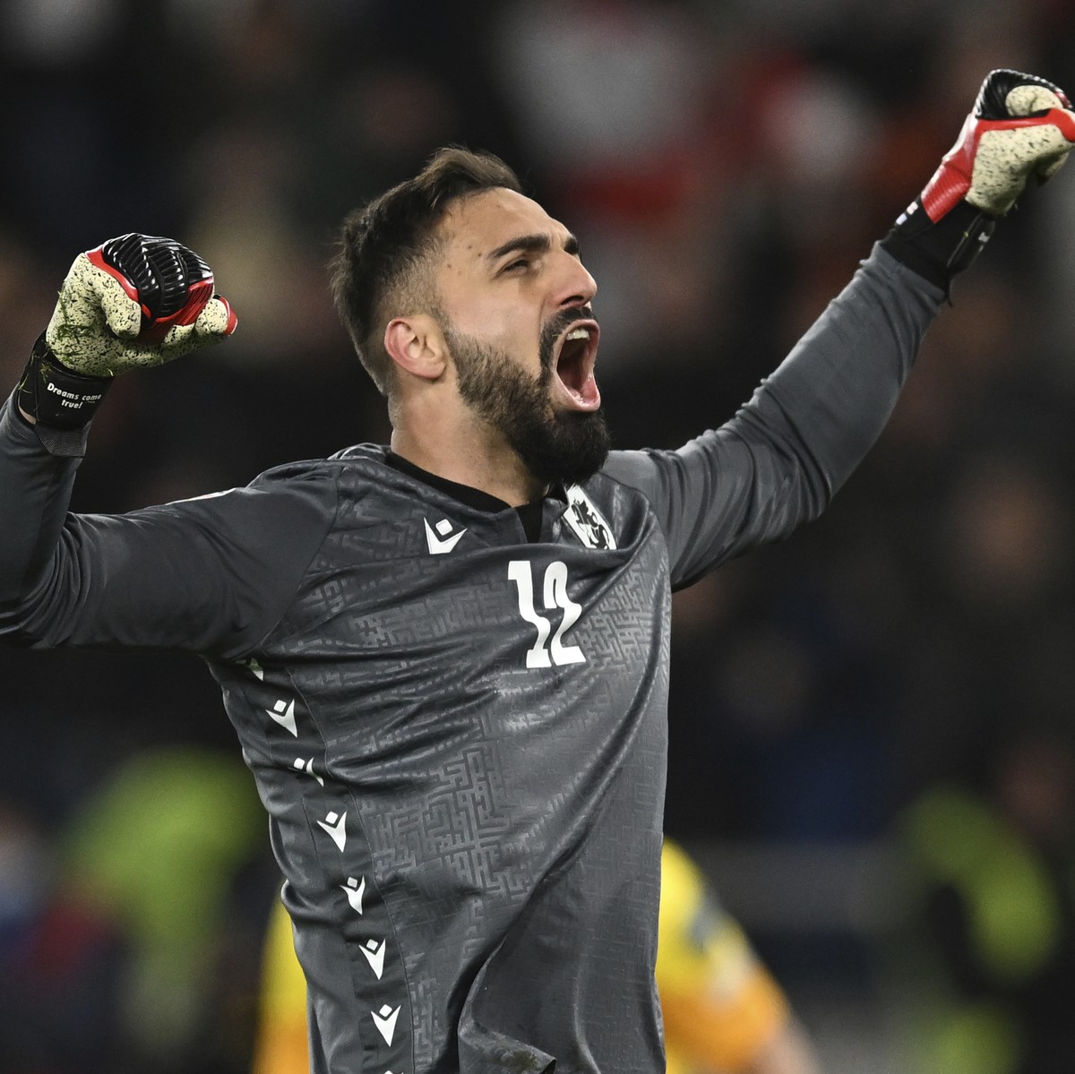 Georgia's goalkeeper Giorgi Mamardashvili reacts after his save during a penalty shootout at the end of the Euro 2024 qualifying play-off soccer match between Georgia and Greece at the Boris Paic ...
