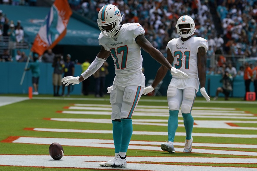 Miami Dolphins wide receiver Jaylen Waddle (17) and running back Raheem Mostert (31) do a dance after Waddle scored a touchdown during the first half of an NFL football game against the New England Pa ...