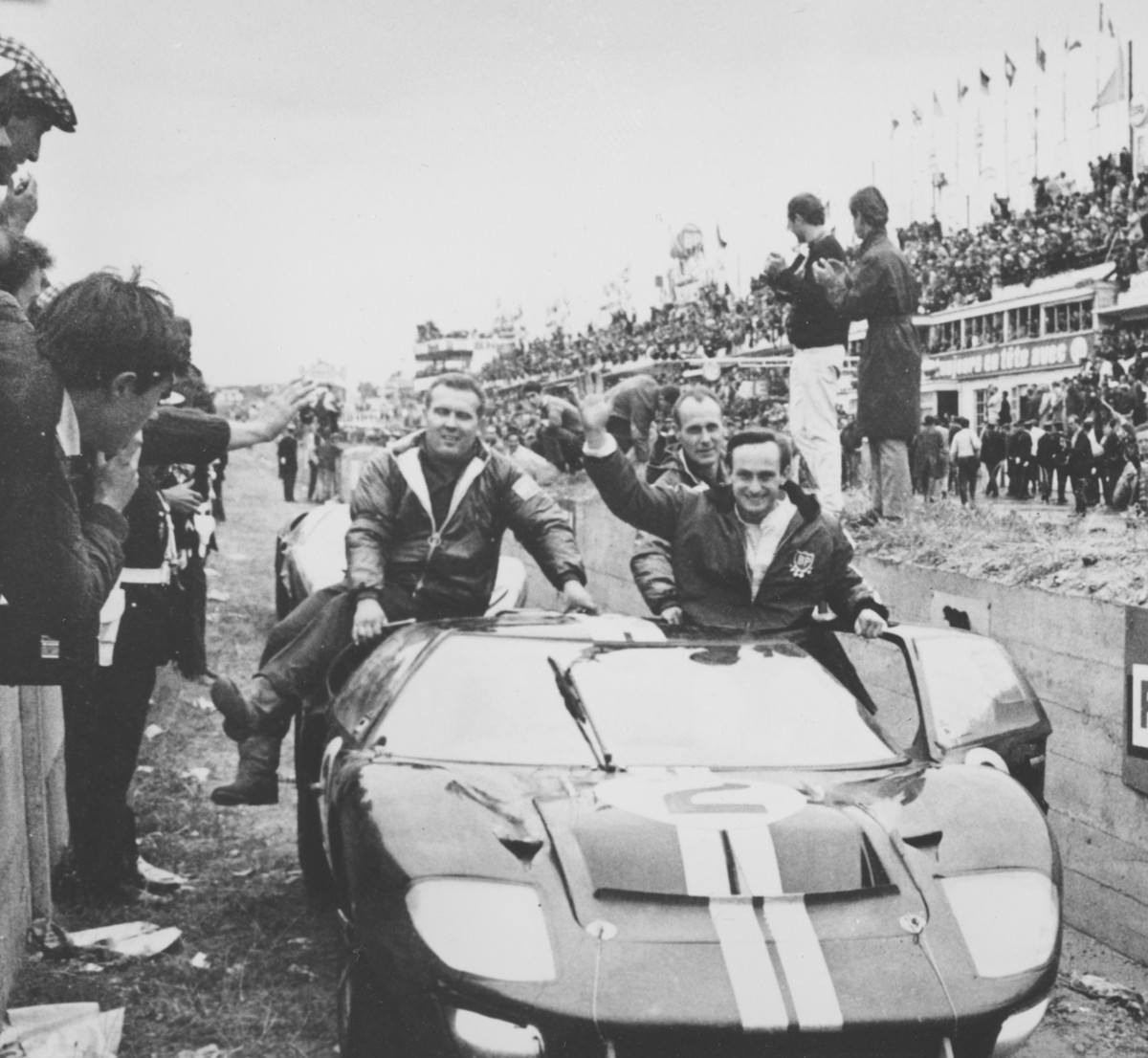 New Zealand's Chris Amon, right, waves to the crowd from his 7-litres Ford automobile after he and compatriot Bruce McLaren, not shown, won the 24-hours endurance for sports cars, at Le Mans, Fra ...