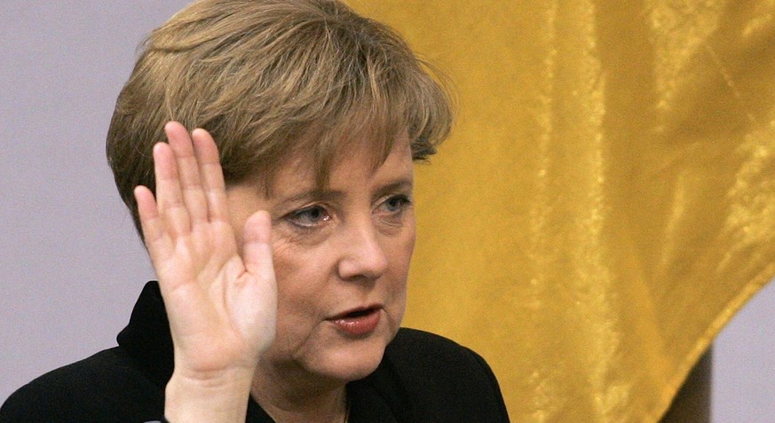 FILE - In this Nov. 22, 2005 file photo newly elected German Chancellor Angela Merkel takes the oath in the German parliament in Berlin. Merkel marks her 10th anniversary at the helm of Germany on Sun ...