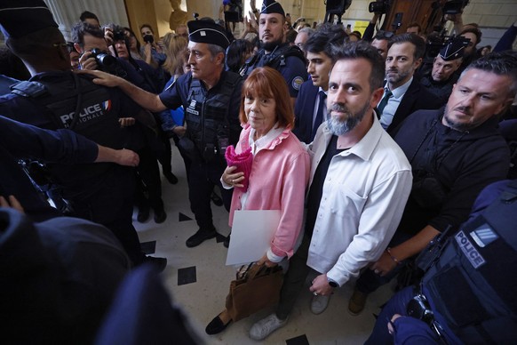 epa12442242 Gisele Pelicot (C-L) accompanied by her son Florian Pelicot (C-R) leaves the Gard criminal court, in Nimes, France, 09 October 2025. An appeal trial involving one of the defendants sentenc ...