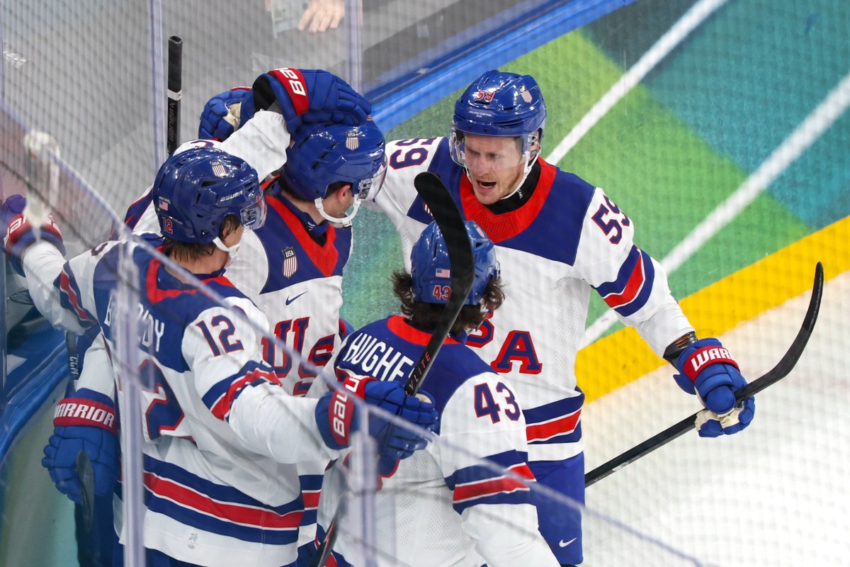 epa12744960 Players of USA celebrate scoring a goal during the Men's Preliminary Round match USA against Germany of the Ice Hockey competitions, at the Milano Cortina 2026 Winter Olympic Games in ...