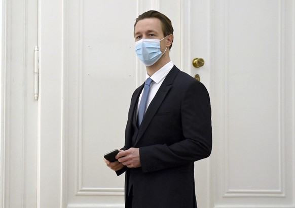 epa08820132 Austrian Finance Minister Gernot Bluemel listens Austrian to Chancellor Sebastian Kurz speakin at the press conference at the Austrian Chancellery in Vienna, Austria, 14 November 2020. The ...