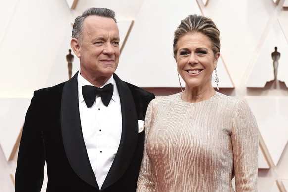 FILE - In this Sunday, Feb. 9, 2020 file photo, Tom Hanks, left, and Rita Wilson arrive at the Oscars at the Dolby Theatre in Los Angeles. On Friday, March 13, 2020, The Associated Press reported on a ...