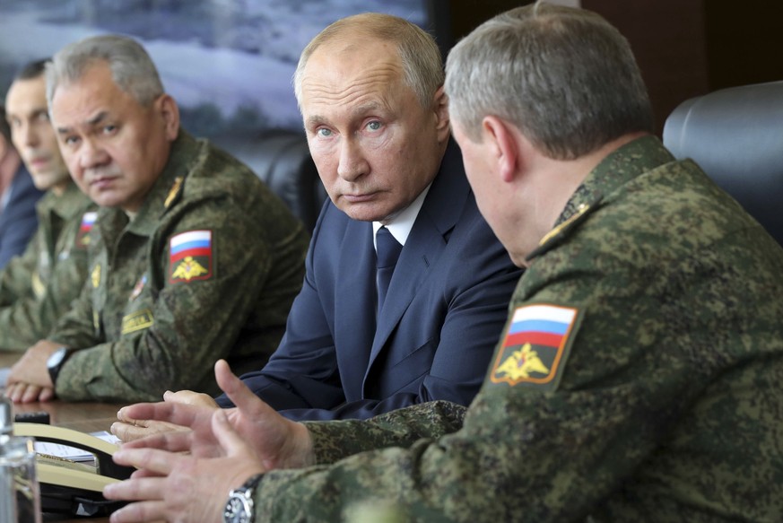 FILE - Russian President Vladimir Putin, center, and Russian Defense Minister Sergei Shoigu, left, attend the main stage of the Kavkaz-2020 strategic command-and-staff exercises at the Kapustin Yar tr ...