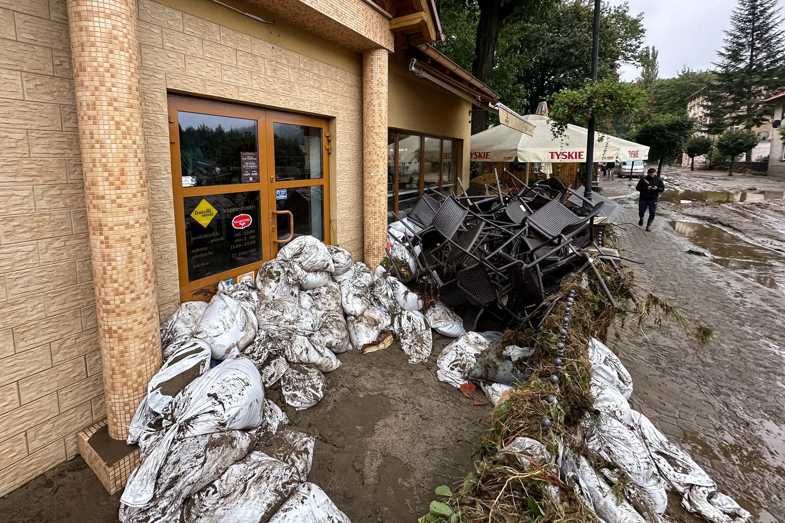 epa11606579 A restaurant is covered with sandbags to protect from floods after heavy rainfalls in Glucholazy, southwestern Poland, 15 September 2024. The southern regions of Poland are experiencing re ...