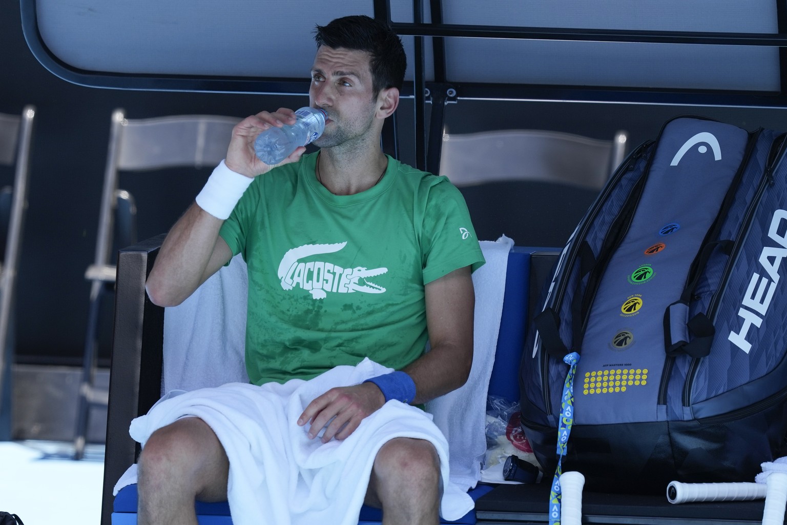 Defending men&#039;s champion Serbia&#039;s Novak Djokovic rests during a practice session on Margaret Court Arena ahead of the Australian Open tennis championship in Melbourne, Australia, Thursday, J ...