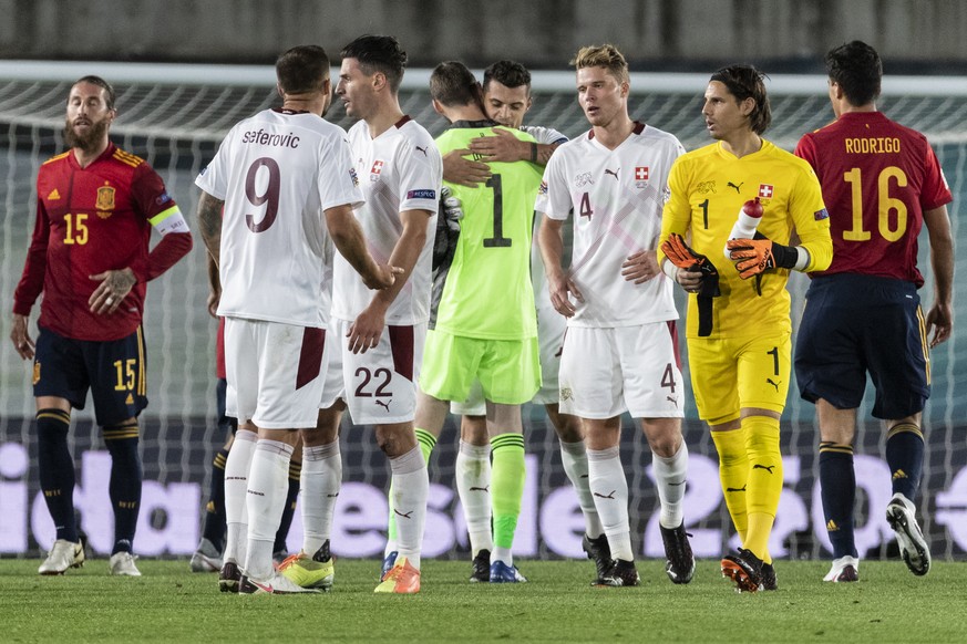 Players looks on, from left, Spain�s Sergio Ramos, Switzerland&#039;s Haris Seferovic, Fabian Schaer, Spain�s goalkeeper David de Gea hugging Switzerland&#039;s Granit Xhaka, Switzerland�s Nico Elvedi ...