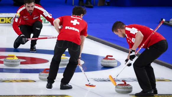 Switzerland skip Peter De Cruz, left, directs his teammates as they play Germany at the Men&#039;s World Curling Championships in Calgary, Alberta, Saturday, April 3, 2021. (Jeff McIntosh/The Canadian ...