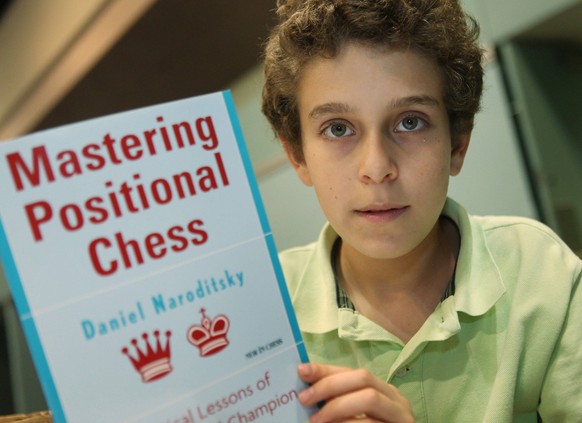 HBY-CMP-CHESSMASTER Daniel Naroditsky, 14, of Foster City, California, holds up his chess book, on April 17, 2010. Naroditsky is the top-ranked American chess player in his age group. Jim Gensheimer/S ...