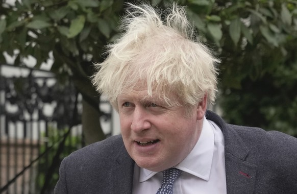 Former British Prime Minister Boris Johnson leaves his home, in London, Tuesday, March 21, 2023. (AP Photo/Kin Cheung)