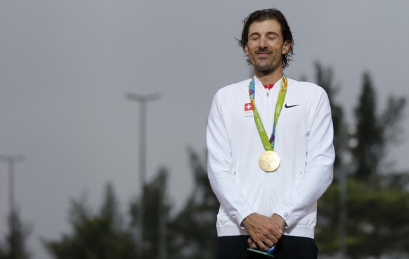 Gold medalist Fabian Cancellara of Switzerland listens to the national anthem during the medal ceremony after the men&#039;s time trial road race in Rio de Janeiro, Brazil, at the Rio 2016 Olympic Sum ...
