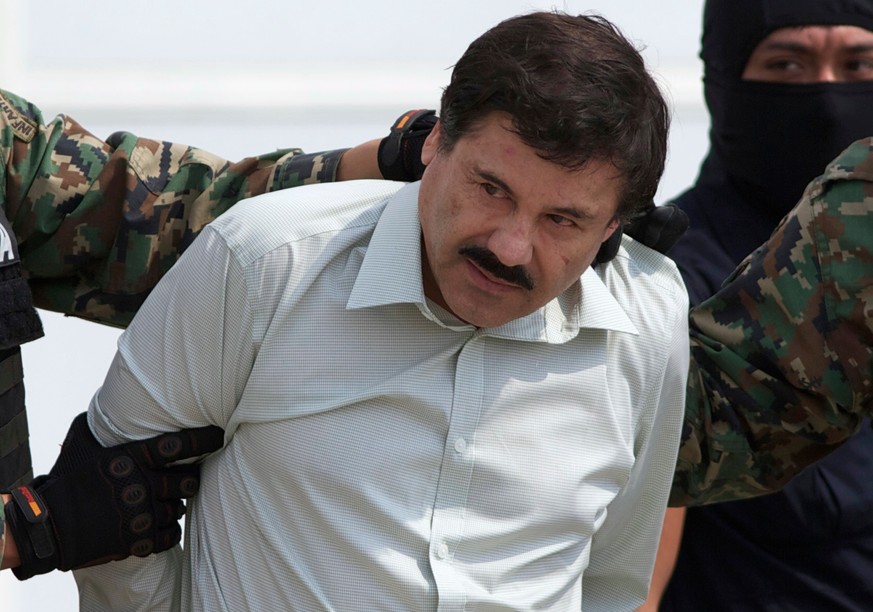 FILE - This Feb. 22, 2014 file photo shows Joaquin &quot;El Chapo&quot; Guzman, the head of Mexico&#039;s Sinaloa Cartel, being escorted to a helicopter in Mexico City following his capture overnight  ...