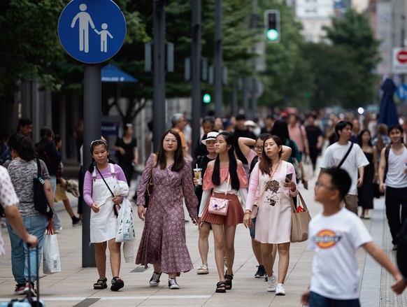 epa11380936 People walk in Nanjing Road main shopping and tourist area in Shanghai, China, 30 May 2024 (issued on 31 May 2024). The official NBS Manufacturing Purchasing Managers Index (PMI) in China  ...
