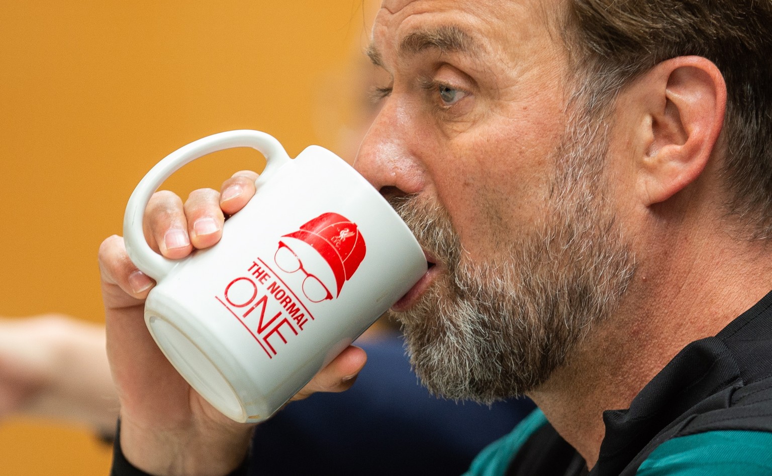 epa09974774 Liverpool&#039;s manager Juergen Klopp drinks from a mug during a press conference held in the Axa Training Centre, Liverpool, Britain, 25 May 2022. Liverpool FC will face Real Madrid CF i ...