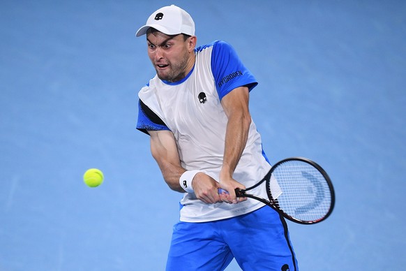 epa09685057 Aslan Karatsev of Russia in action during his semi final match against Daniel Evans of Britain at the Sydney Tennis Classic tournament at Sydney Olympic Park in Sydney, Australia, 14 Janua ...