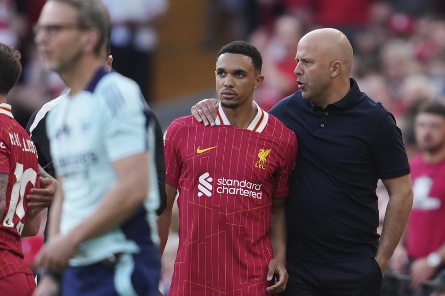 Liverpool&#039;s manager Arne Slot, right, gives instructions to Liverpool&#039;s Trent Alexander-Arnold during the English Premier League soccer match between Liverpool and Arsenal, at Anfield stadiu ...