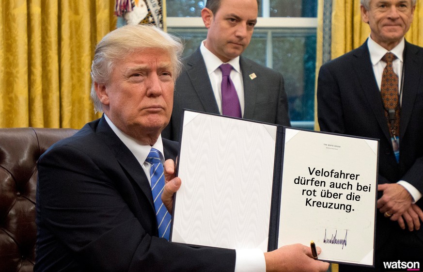 epa05744777 US President Donald J. Trump shows the Executive Order withdrawing the US from the Trans-Pacific Partnership (TPP) after signing it in the Oval Office of the White House in Washington, DC, ...