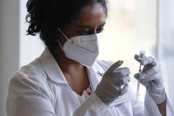 epa10104698 Healthcare worker Sapana Patel prepares a syringe with a dose of the Monkeypox vaccine, at a vaccination clinic at the West Hollywood Library, in West Hollywood, California, USA, 03 August ...