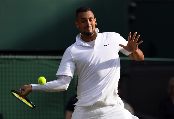 epa07695485 Nick Kyrgios of Australia returns to Rafael Nadal of Spain in their second round match during the Wimbledon Championships at the All England Lawn Tennis Club, in London, Britain, 04 July 2 ...