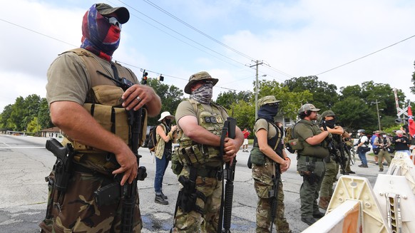epa08605937 Far-right groups, including militia and white supremacists, demonstrate on Main Street at a rally in Stone Mountain, Georgia, U.S., August 15, 2020. The rally is said to be a…