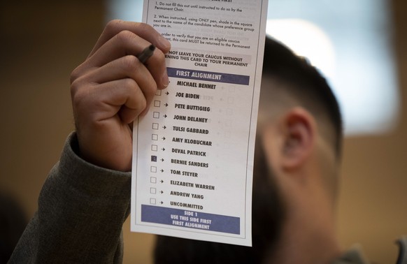 epa08239072 A US senator Bernie Sanders supporter brandishes his ballot during the Nevada Caucus Day in Las Vegas, Nevada, USA, 22 February 2020. EPA/CHRISTIAN MONTERROSA