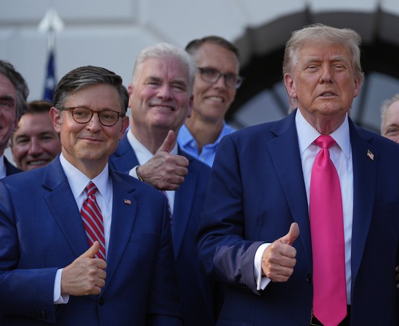 President Donald Trump poses for a photo with first lady Melania Trump, House Speaker Mike Johnson of La., and others, after he signed his signature bill of tax breaks and spending cuts at the White H ...