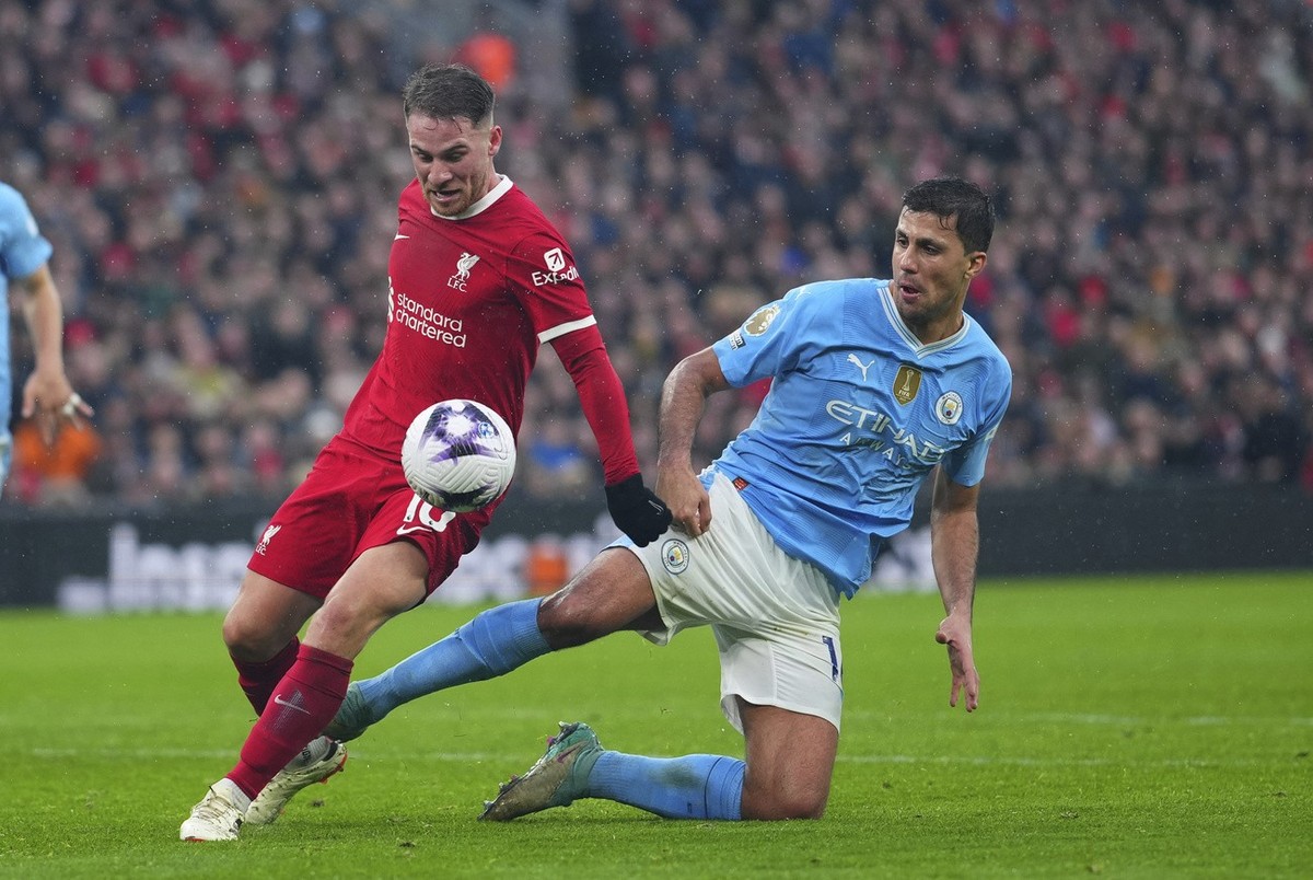 Manchester City's Rodrigo, right, and Liverpool's Alexis Mac Allister fight for the ball during the English Premier League soccer match between Liverpool and Manchester City, at Anfield stad ...