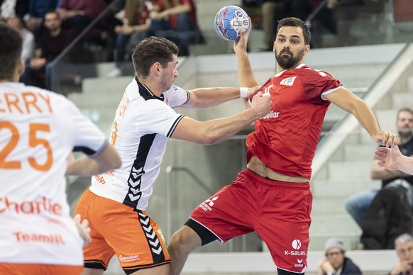 Netherlands' Robin Schoenaker, left, in action against Switzerland's Lukas Von Deschwanden, right, during the Yellow Cup Handball game between Switzerland and Netherlands in Switzerland, Win ...