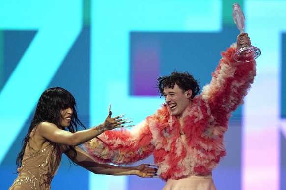 Nemo of Switzerland, who performed the song The Code, celebrates with last year's winner Loreen of Sweden after winning the Grand Final of the Eurovision Song Contest in Malmo, Sweden, Sunday, Ma ...