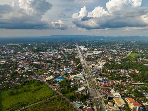 Commercial buildings and houses in Tagum City. Davao del Norte, Philippines. xkwx Tagum city cityscape downtown building district town houses residential area village vacation street Davao del Norte a ...