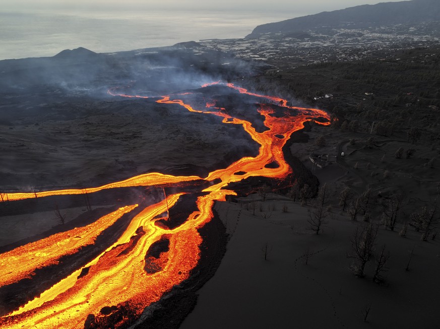 Lava flows as volcano continues to erupt on the Canary island of La Palma, Spain, Monday, Nov. 29, 2021. Several new volcanic vents opened in La Palma on Sunday, releasing new lava that flowed fast do ...