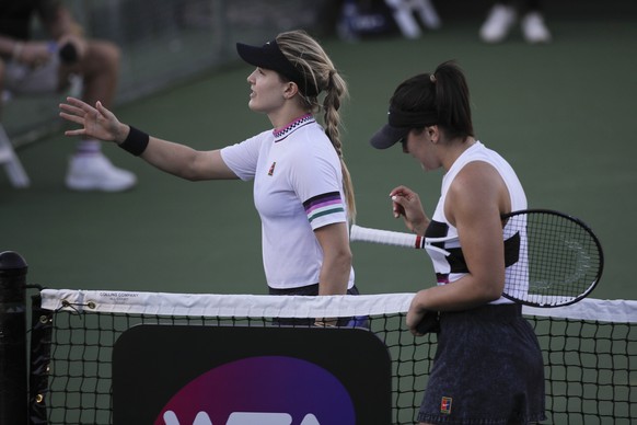 Eugenie Bouchard, left, and Bianca Andreescu walk toward an umpire to shake hands after their quarterfinal at the Oracle Challenger Series tennis tournament Friday, Jan. 25, 2019, in Newport Beach, Ca ...