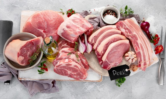 Assortment of raw pork meat on light grey background. Organic gourmet food concept. Top view, flat lay